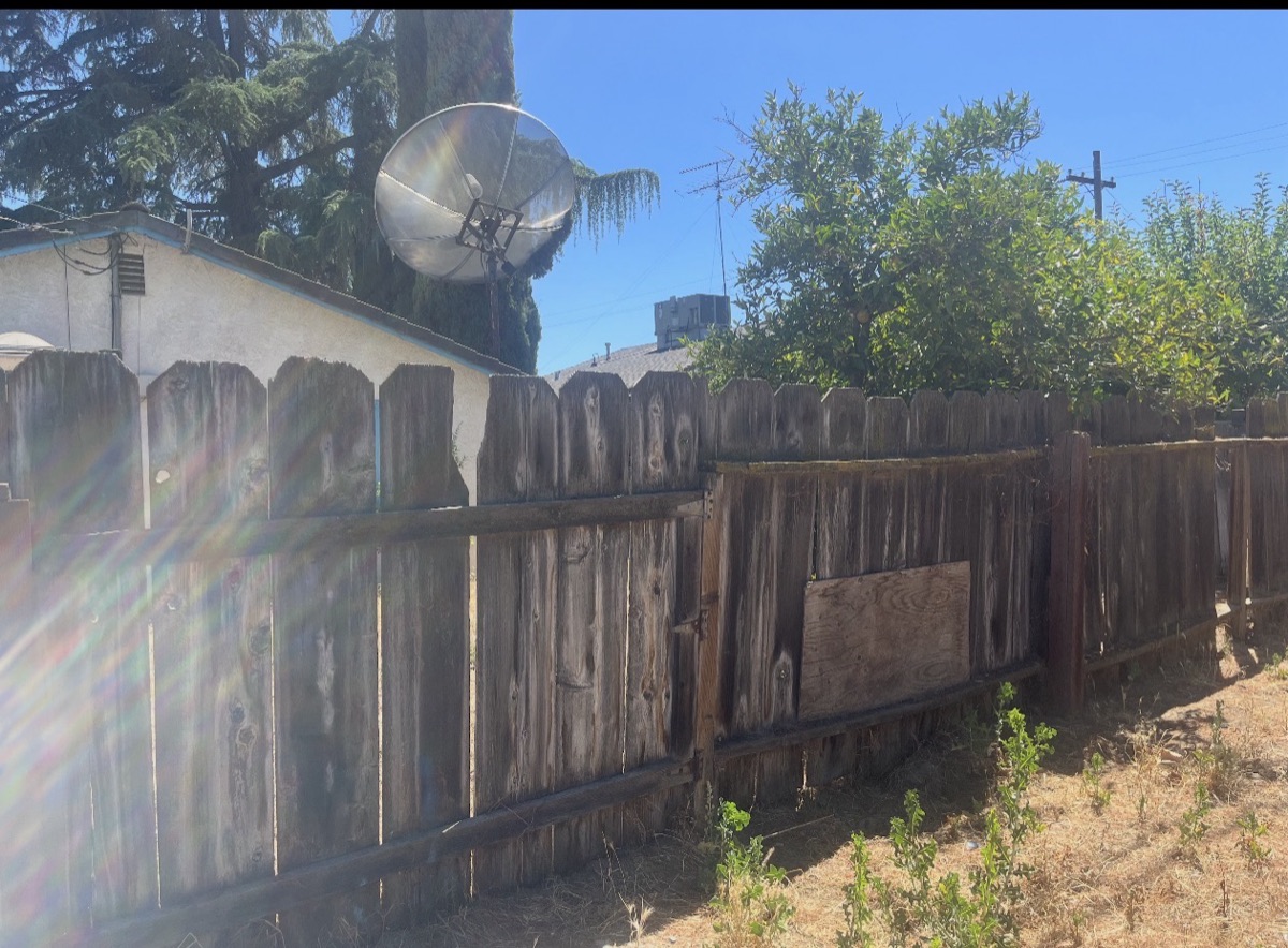 Weathered wood fence before replacement, Merced, CA